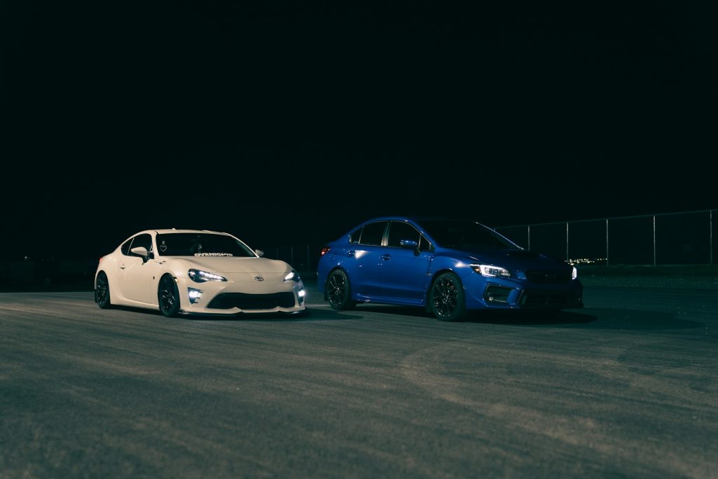 white and blue sports cars night